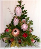 Proteas and fynbos from South Africa artistically arranged in a pottery vase - Click to enlarge